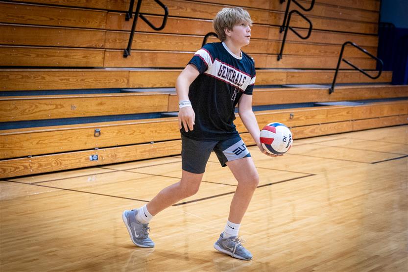 Students play volleyball in PE